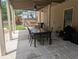 Covered patio area featuring outdoor dining set and ceiling fan for backyard enjoyment at 212 Wilshire Ter, White, GA 30184
