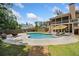 Backyard oasis features a kidney-shaped pool, patio area, and lush landscaping at 212 Wilshire Ter, White, GA 30184