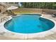 Sparkling blue pool is surrounded by a concrete patio, perfect for summer relaxation at 212 Wilshire Ter, White, GA 30184