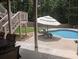 Outdoor pool area with patio, lounge chairs, dining table, and access to the home at 212 Wilshire Ter, White, GA 30184