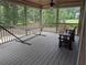 Relaxing screened porch with wood floors, hammock, ceiling fan, and a view of the backyard at 212 Wilshire Ter, White, GA 30184