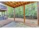 View from under the deck with backyard, woods, and wrought iron fence at 5207 Merrimont Dr, Alpharetta, GA 30022