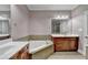 Comfortable bathroom with a soaking tub, dual sinks, and a separate shower at 5207 Merrimont Dr, Alpharetta, GA 30022