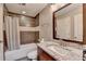 Updated bathroom with modern vanity, framed mirror, and shower with a tub at 5207 Merrimont Dr, Alpharetta, GA 30022