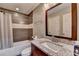 Bathroom with granite countertop, tiled shower, and modern fixtures at 5207 Merrimont Dr, Alpharetta, GA 30022