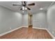 Bedroom featuring wood floors, ceiling fan, and neutral paint at 5207 Merrimont Dr, Alpharetta, GA 30022