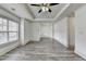 Bright bedroom showcasing wood-look floors, ample natural light, and a ceiling fan at 5207 Merrimont Dr, Alpharetta, GA 30022