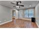 Well-lit bedroom with a ceiling fan, hardwood floors, a back door, and neutral paint at 5207 Merrimont Dr, Alpharetta, GA 30022