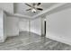 Open bedroom space with gray floors, white walls, and a modern ceiling fan at 5207 Merrimont Dr, Alpharetta, GA 30022