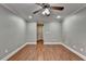 Bedroom showcasing wood floors, ceiling fan, and neutral paint at 5207 Merrimont Dr, Alpharetta, GA 30022