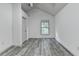 A bright bedroom with a gray-toned floor is illuminated by a window at 5207 Merrimont Dr, Alpharetta, GA 30022