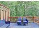 Spacious deck with wooden railings, outdoor furniture, and a treed backyard at 5207 Merrimont Dr, Alpharetta, GA 30022
