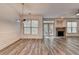 Dining room next to a living room with a stone fireplace and a door leading to an outdoor deck at 5207 Merrimont Dr, Alpharetta, GA 30022