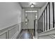 Elegant entryway with gray floors, white trim, and staircase with black iron spindles at 5207 Merrimont Dr, Alpharetta, GA 30022