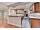 Kitchen features custom cabinets, granite countertops, stainless appliances, and breakfast bar at 5207 Merrimont Dr, Alpharetta, GA 30022