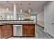 Open-concept kitchen featuring island with stainless dishwasher and open to living area at 5207 Merrimont Dr, Alpharetta, GA 30022