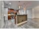 Modern kitchen with stainless appliances, rich wood cabinets and island with stone facing at 5207 Merrimont Dr, Alpharetta, GA 30022
