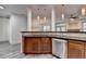 Gourmet kitchen island with granite countertops, stainless steel dishwasher and view to the Gathering room at 5207 Merrimont Dr, Alpharetta, GA 30022