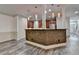 Spacious kitchen with island featuring stone accents and a view of the staircase at 5207 Merrimont Dr, Alpharetta, GA 30022