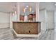 Open kitchen with modern light fixtures, stainless appliances, mosaic countertop, and gray hardwood style floors at 5207 Merrimont Dr, Alpharetta, GA 30022