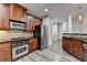 Spacious kitchen with granite counters, stainless appliances, and a view into the living area at 5207 Merrimont Dr, Alpharetta, GA 30022