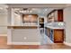 Kitchen features custom cabinets, granite countertops, stainless appliances, and mosaic backsplash at 5207 Merrimont Dr, Alpharetta, GA 30022