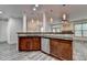 Gourmet kitchen island with granite countertops, stainless steel dishwasher and view to the Gathering room at 5207 Merrimont Dr, Alpharetta, GA 30022
