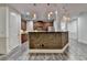Well-designed kitchen with an island featuring stone accents and a view of the staircase at 5207 Merrimont Dr, Alpharetta, GA 30022