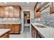 Kitchen features custom cabinets, granite countertops, stainless appliances, and walk-in access to bath at 5207 Merrimont Dr, Alpharetta, GA 30022
