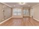 Spacious living room featuring hardwood floors, neutral paint, and bright windows at 5207 Merrimont Dr, Alpharetta, GA 30022