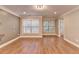 Bright living room with hardwood floors, crown molding, and modern lighting at 5207 Merrimont Dr, Alpharetta, GA 30022