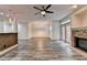 Open-concept living room with a stone fireplace and modern floors; the kitchen is partially visible at 5207 Merrimont Dr, Alpharetta, GA 30022