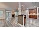 Open living space with gray floors, fireplace, and bar area, seamlessly blending kitchen and lounge at 5207 Merrimont Dr, Alpharetta, GA 30022