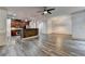 Open-concept floor plan with kitchen in background and living room with stylish gray wood-look floors at 5207 Merrimont Dr, Alpharetta, GA 30022