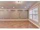 Living room features hardwood floors, crown molding, and a large window at 5207 Merrimont Dr, Alpharetta, GA 30022