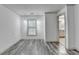 Open living room with views of the bathroom, natural light, and hardwood style floors at 5207 Merrimont Dr, Alpharetta, GA 30022