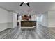 Open-concept floor plan with kitchen in background and living room with stylish gray wood-look floors at 5207 Merrimont Dr, Alpharetta, GA 30022