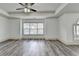 Open living room with a ceiling fan, natural light, and hardwood style floors at 5207 Merrimont Dr, Alpharetta, GA 30022