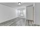 An open living room featuring large windows to let in ample natural light and hardwood style floors at 5207 Merrimont Dr, Alpharetta, GA 30022