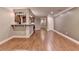 Open-concept living area with hardwood floors and a convenient breakfast bar at 5207 Merrimont Dr, Alpharetta, GA 30022