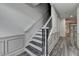 Gray laminate staircase leading to a bright hallway, complemented by white trim and modern design at 5207 Merrimont Dr, Alpharetta, GA 30022