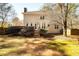 View of backyard with deck, mature trees and two-story siding at , Lilburn, GA 30047
