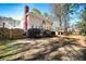 Spacious backyard featuring well-maintained lawn, deck, mature trees, and privacy fence at , Lilburn, GA 30047