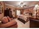 Spacious bedroom with a ceiling fan, luxurious bedding, and decorative accents at , Lilburn, GA 30047