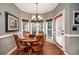 Cozy breakfast nook with a round table, wood chairs, and natural light from surrounding windows at , Lilburn, GA 30047