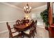 Elegant dining room featuring a wooden table, upholstered chairs, and a chandelier at , Lilburn, GA 30047