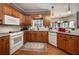 Bright kitchen with granite counters, wood cabinets, and white appliances at , Lilburn, GA 30047