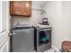 Functional laundry room with washer, dryer, and overhead storage at , Lilburn, GA 30047