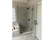 Modern shower with glass doors and light grey tiled walls and pebble floor at , Lilburn, GA 30047