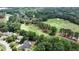 Stunning aerial view of a golf course winding through a residential area, surrounded by lush trees and well-kept homes at 119 Kennemer Ct, Duluth, GA 30097